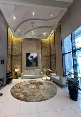 a large lobby with a couch and a table at Tahanan Studio at Salcedo Skysuites in Manila