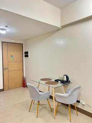 a dining room with a table and two chairs at Big Studio Condo Across Manila Airport NAIA T3 WITH WIFI in Manila