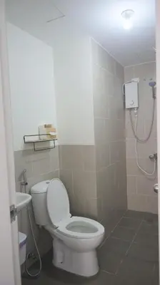 a bathroom with a toilet and a shower at Holly's Place by Motorists Transient House in Biñan