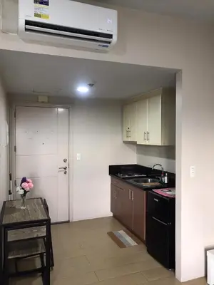 a kitchen with a sink and a stove top oven at Condo Unit Near NAIA T3 in Manila