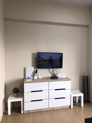 a white dresser with a television on top of it at Condo Unit Near NAIA T3 in Manila