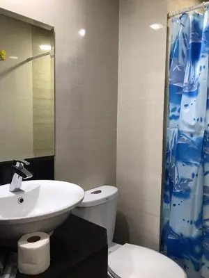 a bathroom with a sink and a toilet and a shower at Condo Unit Near NAIA T3 in Manila