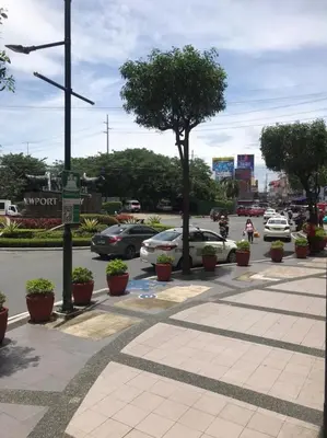 a street with cars parked in a parking lot at Condo Unit Near NAIA T3 in Manila