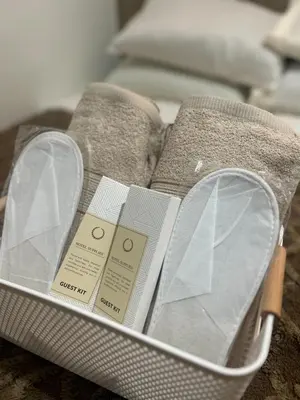 a basket with a book and a pair of shoes at Shore 2 Residences - The Grand Haven in Manila