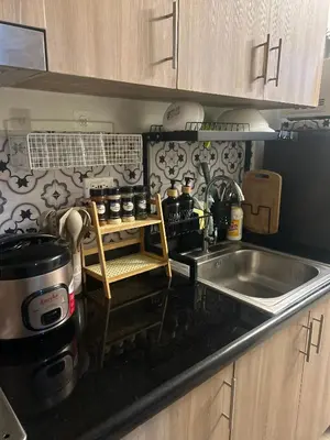 a kitchen with a sink and a counter top at Shore 2 Residences - The Grand Haven in Manila