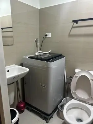 a small bathroom with a toilet and a sink at Shore 2 Residences - The Grand Haven in Manila