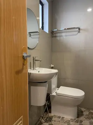 a bathroom with a toilet and a sink and a mirror at airobedz ZOBEL ROXAS- A Value Hotel in Manila