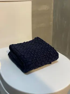 a black blanket sitting on top of a toilet at airobedz ZOBEL ROXAS- A Value Hotel in Manila