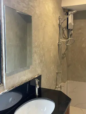 a bathroom with a sink and a mirror at airobedz ZOBEL ROXAS- A Value Hotel in Manila
