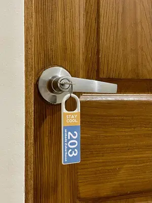 a key tag hanging from a door knob at airobedz ZOBEL ROXAS- A Value Hotel in Manila