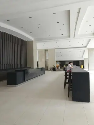 a man sitting at a bar in a lobby at Condo MOA Complex Pasay - Shore 1 Tower D Residence - Home away from Home in Manila