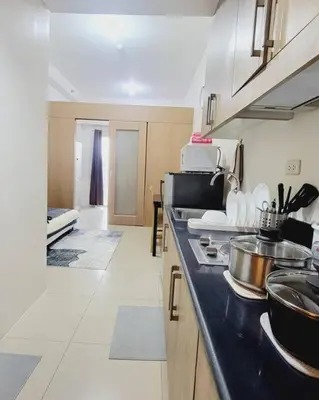 a kitchen with a stove and a counter top at Condo MOA Complex Pasay - Shore 1 Tower C2 Residence - Home away from Home in Manila