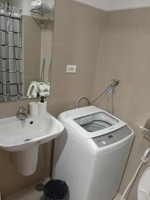 a small bathroom with a toilet and a sink at Condo MOA Complex Pasay - Shore 1 Tower C2 Residence - Home away from Home in Manila