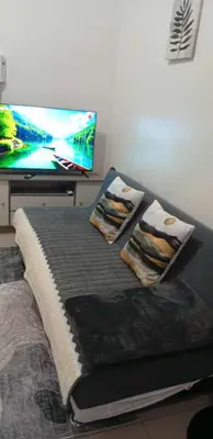 a bed with two pillows and a flat screen tv at Condo MOA Complex Pasay - Shore 1 Tower C2 Residence - Home away from Home in Manila