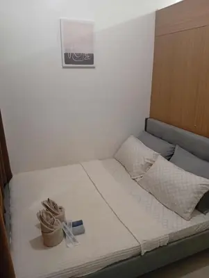 a bed with shoes sitting on top of it at Condo MOA Complex Pasay - Shore 1 Tower C2 Residence - Home away from Home in Manila