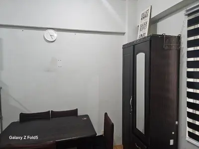 a room with a desk and a keyboard and a table at Casa Tolentino Manila in Manila