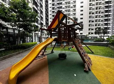 a playground with a slide in a city at Cozy Staycation Suite at Rossy's Place near in Paranaque in Manila