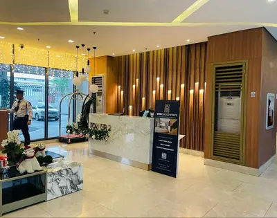 a lobby of a store with a woman standing in it at Cozy Staycation Suite at Rossy's Place near in Paranaque in Manila
