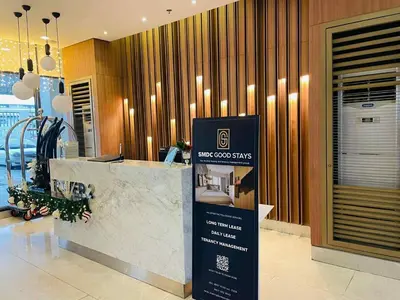 a hotel lobby with a sign in front of a counter at Cozy Staycation Suite at Rossy's Place near in Paranaque in Manila