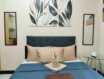 a bedroom with a blue bed with two mirrors at NAIA Manila Airport - Newport Prime Accommodations in Manila
