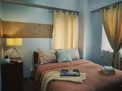 a bedroom with a bed with a tray on it at NAIA Manila Airport - Newport Prime Accommodations in Manila