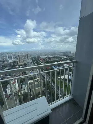 a balcony of a building with a view of a city at Canadian Suite at Coast Residences Penthouse in Manila