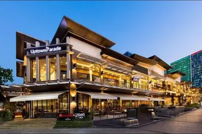a large building with a restaurant on the side of it at Upscale 2BR in Uptown Parksuites with Free Parking in Manila