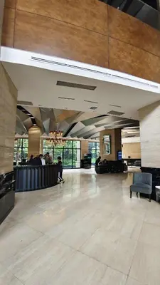 a large lobby with a waiting area in a building at Christine Suites PH at The Gramercy Residences Makati in Manila