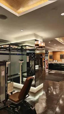 a salon with a chair in a room at Christine Suites PH at The Gramercy Residences Makati in Manila