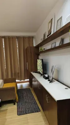 a room with a kitchen with a desk and a bed at Christine Suites PH at The Gramercy Residences Makati in Manila