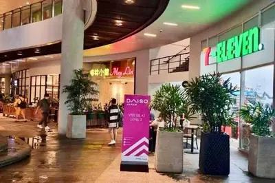 a shopping mall with a pink sign in the middle at Skyline Serenity Designer 1BR with Balcony at Air in Manila