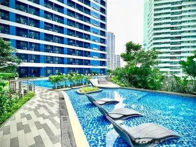 a large swimming pool with chairs in a building at Skyline Serenity Designer 1BR with Balcony at Air in Manila