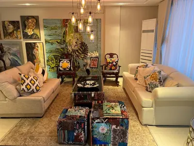 a living room with two couches and a table at Super cozy Family Villa in Manila