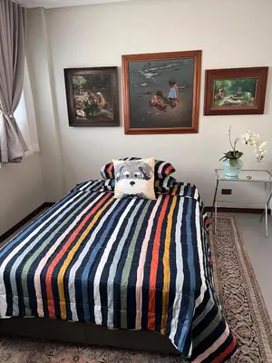 a bedroom with a bed with a stuffed animal on it at Super cozy Family Villa in Manila