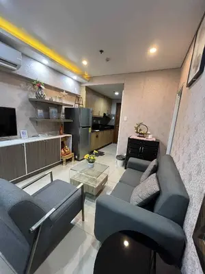 a living room with two couches and a kitchen at MOA Shell Residences Staycation in Manila