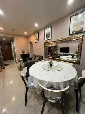 a living room with a table with chairs and a mirror at MOA Shell Residences Staycation in Manila