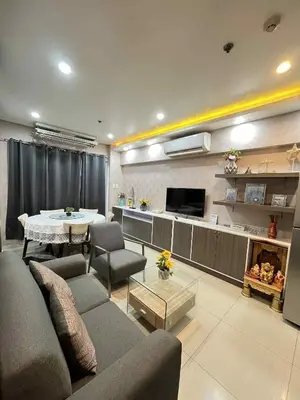 a living room with a couch and a table at MOA Shell Residences Staycation in Manila