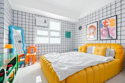 a bedroom with a large yellow bed in it at The Play Haus Aesthetic Studio across NAIA Terminal 3 in Manila