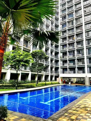 a large apartment building with a large blue swimming pool at Casa Felice at Shore 2 Residences in Manila