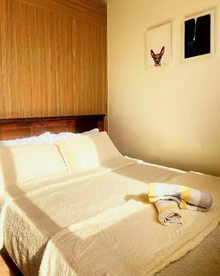 a bed with a towel laying on top of it at Casa Felice at Shore 2 Residences in Manila