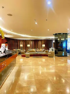 a man is standing in a hotel lobby at Casa Felice at Shore 2 Residences in Manila