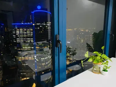 a view of a city skyline from a window at Tropical Chic Escape With City lights View- Modern Scandi in Manila