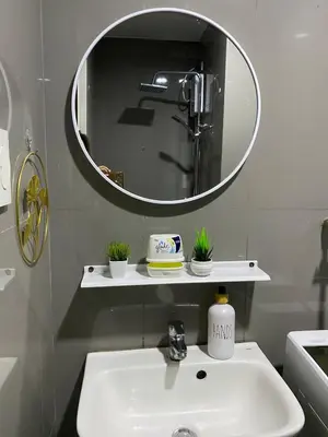 a bathroom with a sink and a mirror at Tropical Chic Escape With City lights View- Modern Scandi in Manila