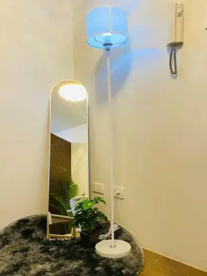 a bathroom with a mirror and a table with a lamp at Tropical Chic Escape With City lights View- Modern Scandi in Manila