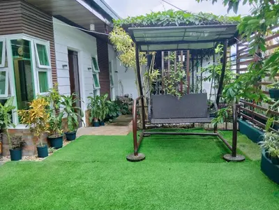 a garden with a chair on a lawn at Delia Secret Garden in Silang