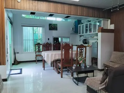 a living room with a bed and a couch and a table at Delia Secret Garden in Silang