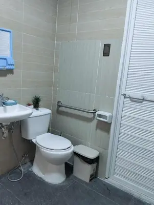 a bathroom with a toilet and a sink at Delia Secret Garden in Silang