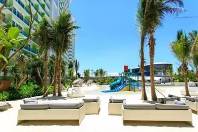 a resort with palm trees and a playground at Azure Skyline Pad in Manila