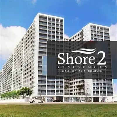 a large building with a sign in front of it at Shore Residences MOA in Manila
