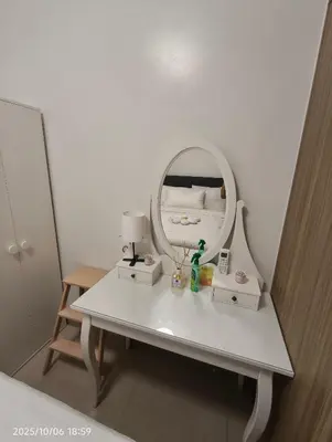 a white dressing table with a mirror and a lamp at Shore Residences MOA in Manila